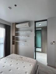 Modern bedroom with a comfortable bed, air conditioning, and wooden furnishings