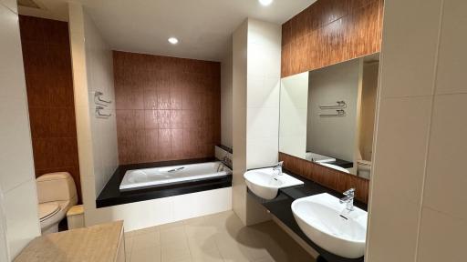 Modern bathroom with bathtub and dual sinks