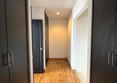 Bright corridor with wooden flooring and multiple doors