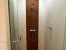 Compact tiled bathroom with shower and wooden door