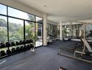 Spacious home gym with modern equipment and large windows