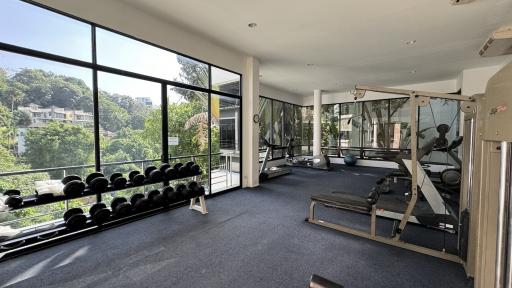 Spacious home gym with modern equipment and large windows