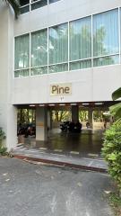 Entrance of the modern Pine building with parking space