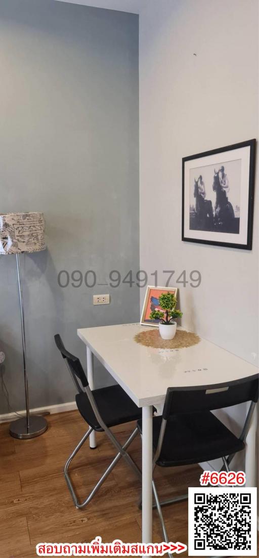 Minimalistic dining space with a white table and two chairs