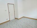 Empty bedroom interior with white walls and tiled floor