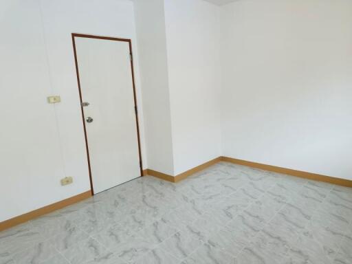 Empty bedroom interior with white walls and tiled floor