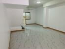 Spacious and Bright Unfurnished Living Room with Tile Flooring