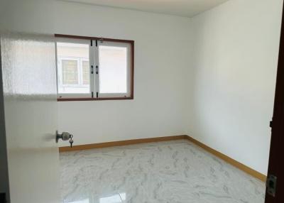 Bright and empty bedroom with tiled floor and a window