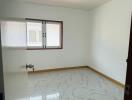 Bright and empty bedroom with tiled floor and a window