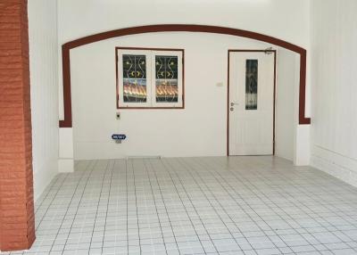 Spacious and well-lit indoor space with tiled floor and framed artwork
