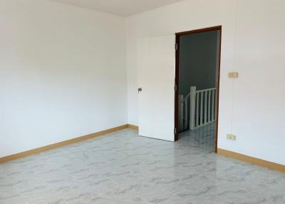 Empty room with open door and tiled flooring