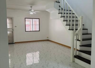 Spacious living room with staircase and marble flooring