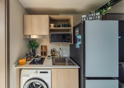 Compact modern kitchen with built-in appliances and space-saving design