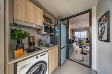 Modern compact kitchen with open view to living area