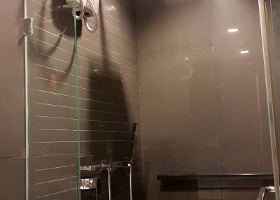 Modern bathroom interior with a glass shower stall and stylish fixtures