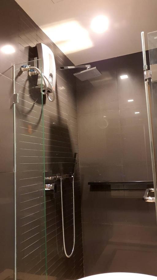 Modern bathroom interior with a glass shower stall and stylish fixtures