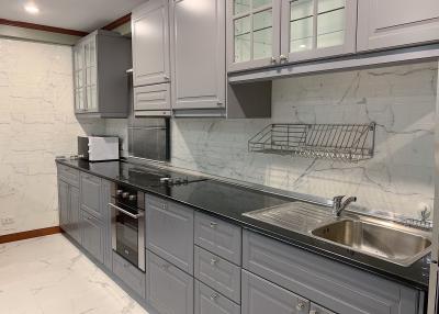 Modern kitchen with stainless steel appliances and marble countertops