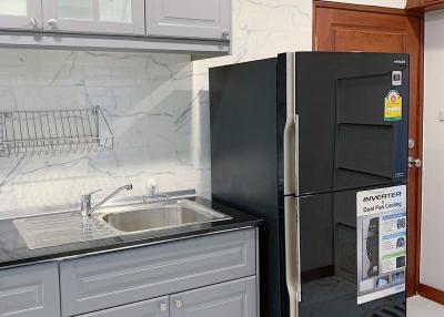 Modern kitchen with stainless steel appliances and marble countertops