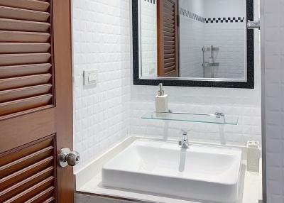 Modern bathroom interior with white brick tiles and wooden accents