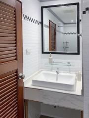 Modern bathroom interior with white brick tiles and wooden accents