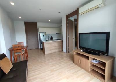 Spacious modern living room with adjacent kitchen