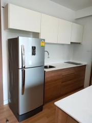 Modern kitchen with stainless steel appliances and wooden cabinetry