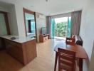 Spacious living room with natural lighting and balcony access