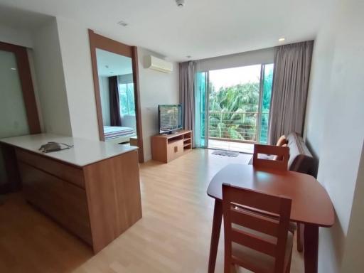 Spacious living room with natural lighting and balcony access