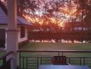 Sunset view from the terrace of a residential home overlooking a tranquil pond