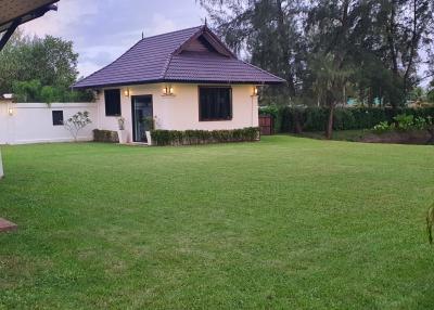 Spacious backyard lawn with a separate guesthouse