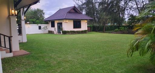 Spacious backyard lawn with a separate guesthouse