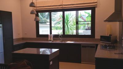 Modern kitchen with large window overlooking greenery