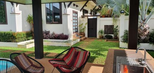 Cozy outdoor patio with seating and lush greenery