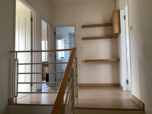 Modern interior space with wooden staircase and minimalistic design