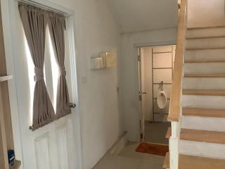 Entrance hall with staircase and door to bathroom