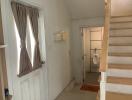 Entrance hall with staircase and door to bathroom