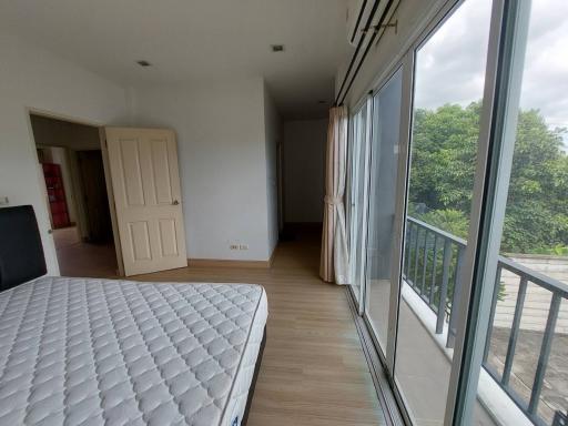 Spacious bedroom with large bed and balcony access