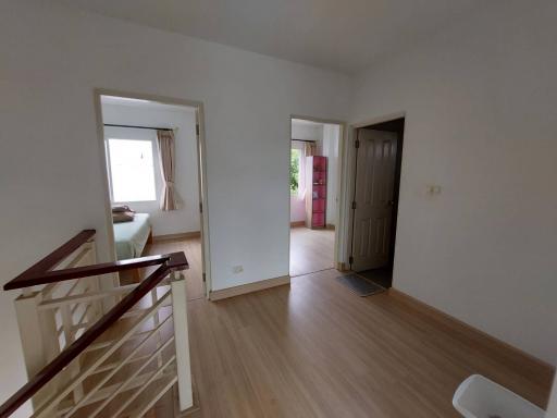 Spacious entryway with view into bedrooms and upper floor access in a residential house