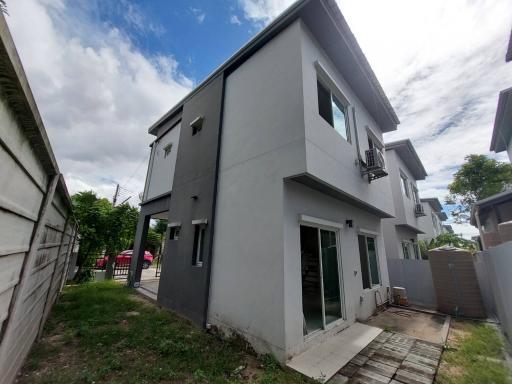 Modern two-story home with a gray exterior and balcony