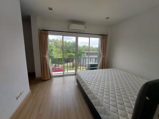 Bright bedroom with large bed and balcony access