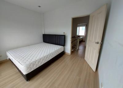 Spacious bedroom with a large bed and wooden flooring