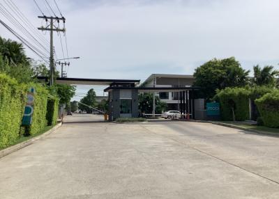 Entrance of a modern residential complex with a security gate