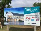 Large billboard advertising residential property with sponsors logos