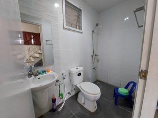 Compact bathroom with white tiles and essential fixtures