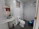 Compact bathroom with white tiles and essential fixtures