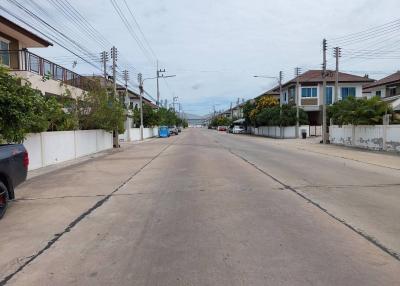 Quiet residential street with houses and parked cars