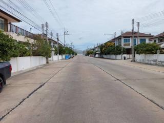 Quiet residential street with houses and parked cars