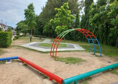 Community park with playground equipment and greenery