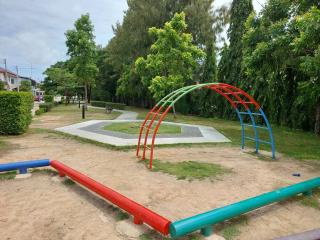 Community park with playground equipment and greenery