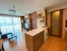 Modern apartment interior view showing open-plan living space with kitchen and living room